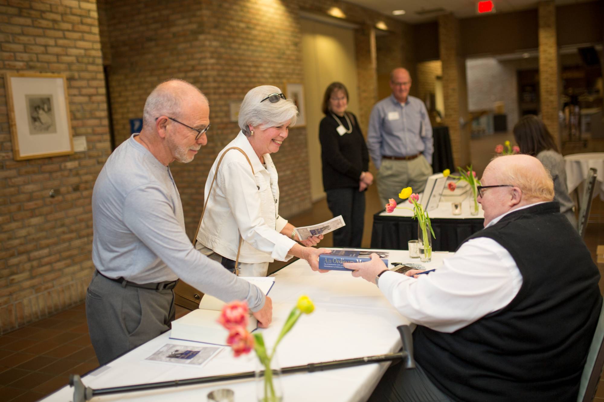 Two people getting their book signed